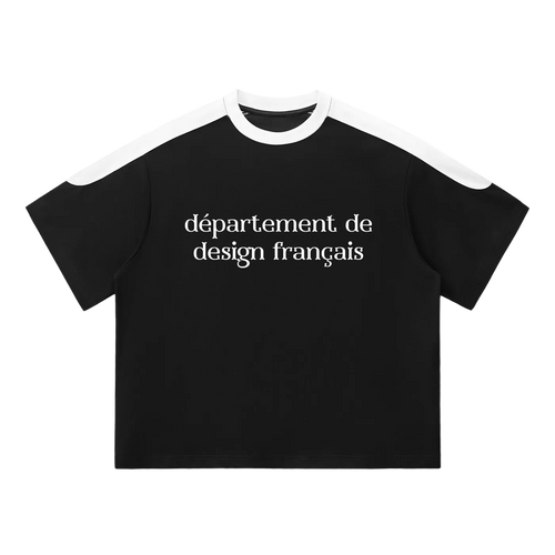 Camiseta oversized negra getabbe con texto "département de design français" en blanco al centro, panel blanco en hombros y cuello redondo en contraste, manga raglán color block, corte holgado unisex, fondo blanco