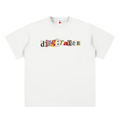 Camiseta blanca getabbe con logo "diegetabbe" en tipografía recortada multicolor estilo ransom note, letras en rojo, amarillo, azul, verde y negro sobre fondos crema y gris, etiqueta con estrella roja, hombro caído, corte largo holgado unisex, fondo blanco